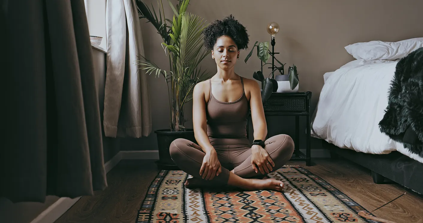 Women meditating next to her bed