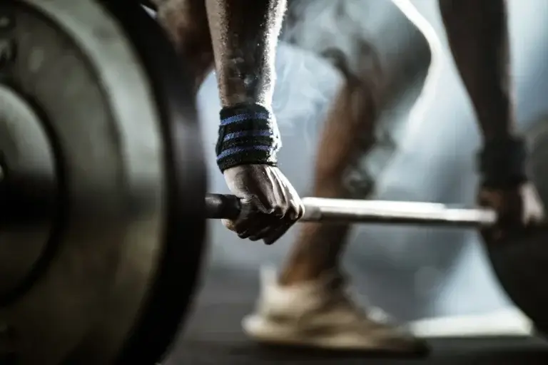 Graphic of someone doing deadlifts with wrist straps