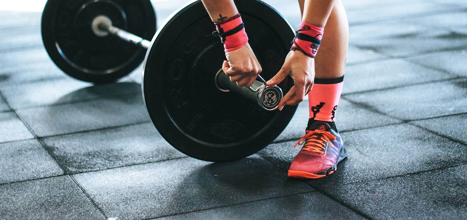 Barbell with clips being attached