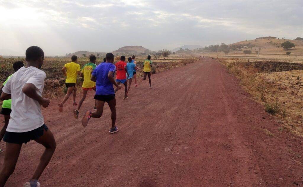 Joggers running down a road in Ethiopia