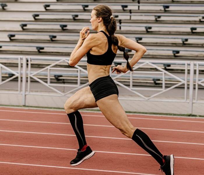 Women sprinter running on a track