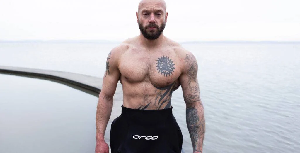 man in wetsuit after swimming