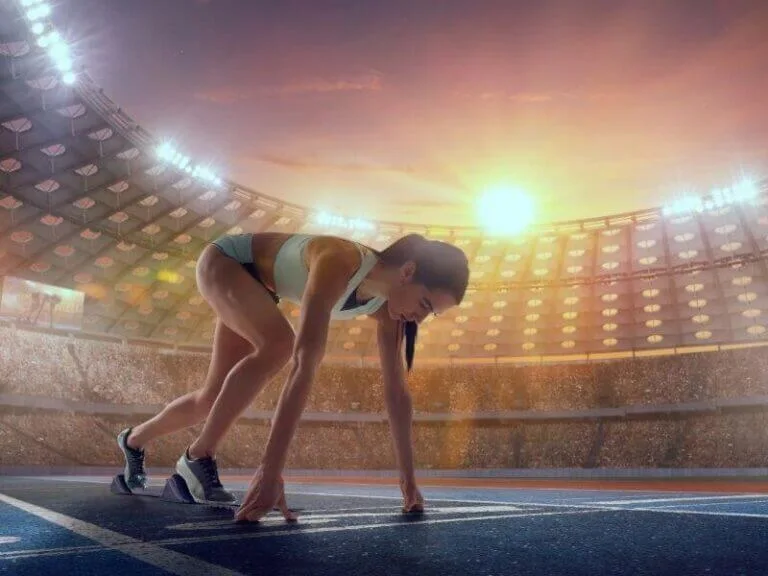 woman on start lane in a stadium ready for a race